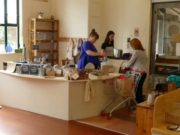 A person is being served at a store counter which is at regular table height