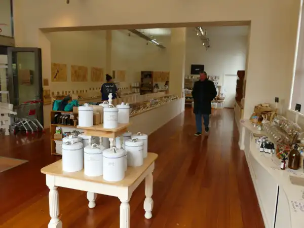 A table in a store containing jars has lots of space around it