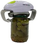 A green and white electric jar opener is positioned on top of a jar of pickles, with teal gripping bars securing the lid.