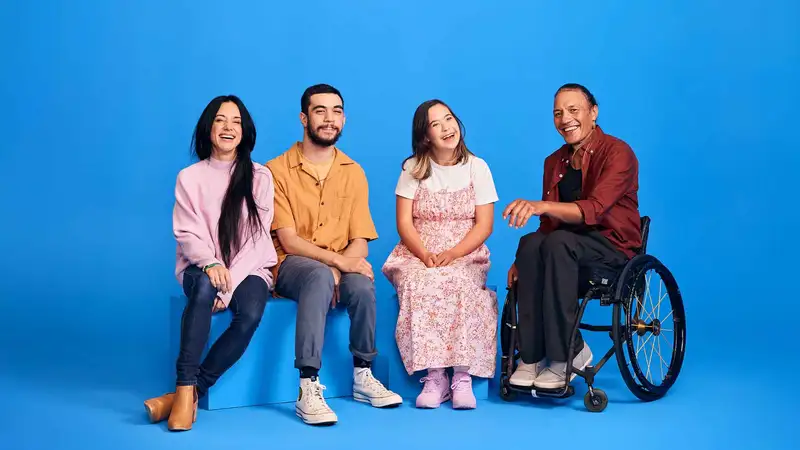 Group photo of Kate, Will, Molly and Rodney - all members of our disabled community against a blue backdrop.