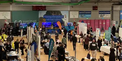 A hall filled with loads of people checking out different stalls all from our disabled community.