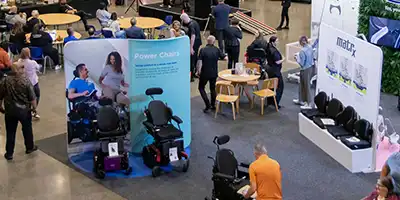 A Birdseye view of a hall filled with multiple disability equipment suppliers.